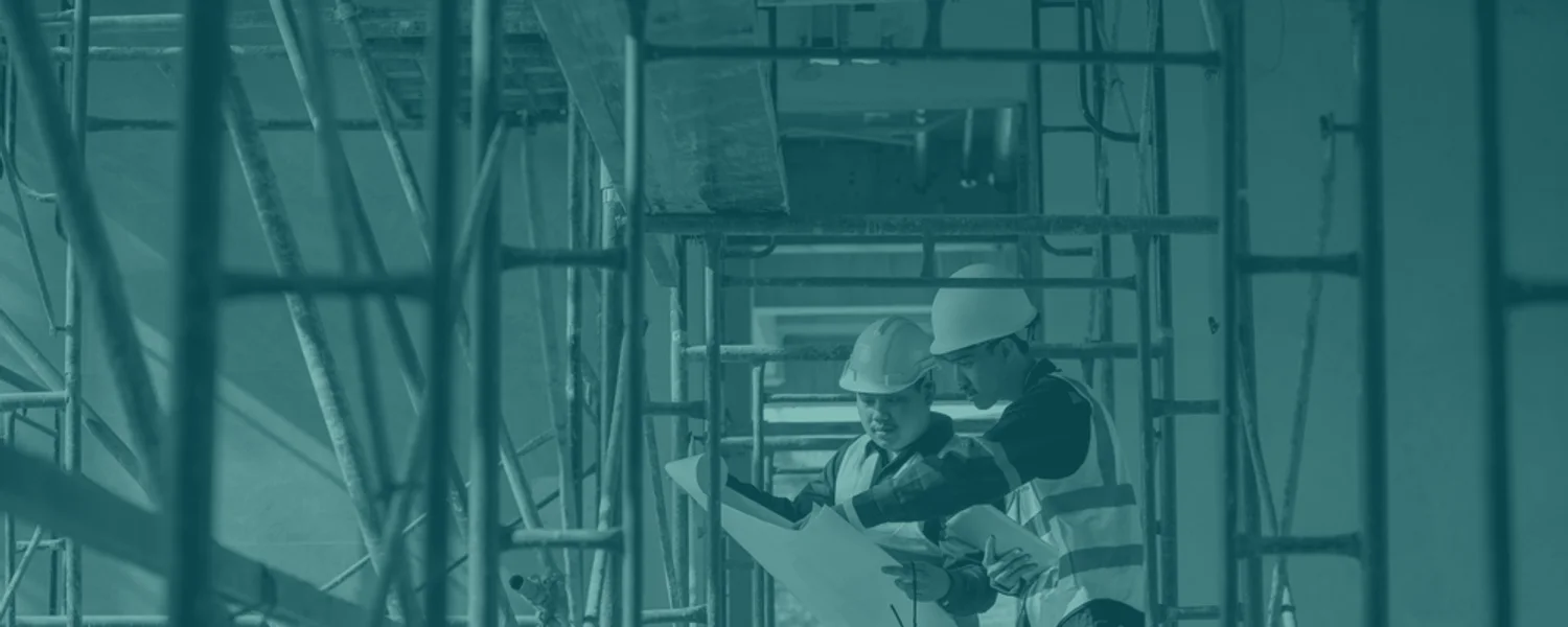 Construction professionals reviewing work inside a large structural project.